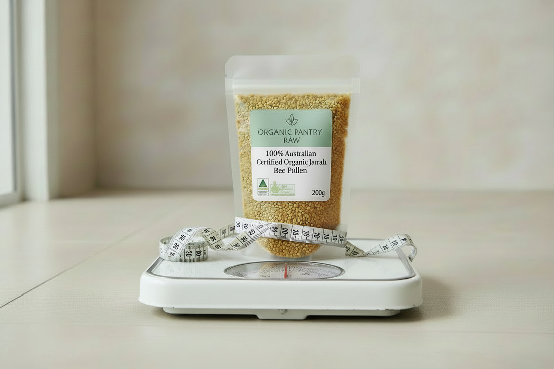 A stand-up pouch of Organic Pantry Raw 100% Australian Certified Organic Jarrah Bee Pollen (200g) resting on a white mechanical weight scale wrapped with a measuring tape.