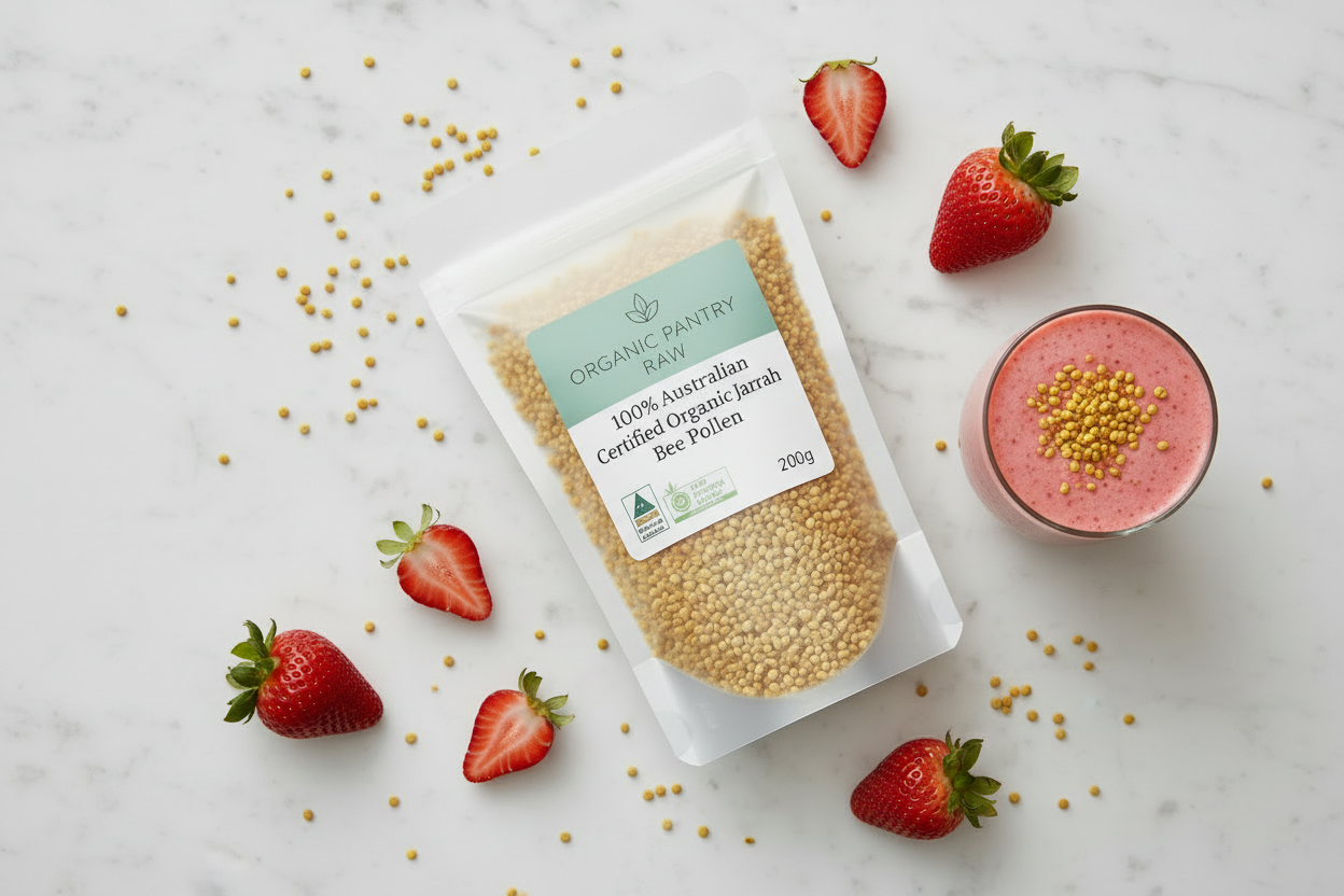 Organic Pantry Raw 200g bag of Australian Certified Organic Jarrah Bee Pollen styled on marble with fresh strawberries and a healthy pink smoothie.